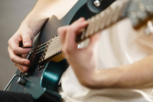 Close Up Of Man Playing On Electric Guitar