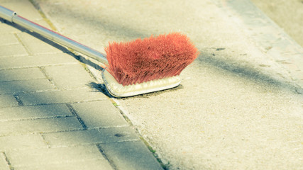 Closeup of orange broom lying down