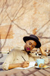 © Carlos David - Portrait of a woman in the park writing by hand, having coffee and croissant