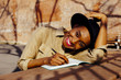 © Carlos David - Woman writing in notebook