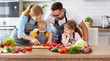 © JenkoAtaman - happy family with children preparing vegetable salad .
