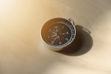 Compass on wood table.