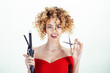 © Svitlana - Smiling girl with curly hair holds hairdresser equipment. Hairdresser. Beauty and style. Beauty industry profession. Makeup and cosmetics for skincare. Isolated on white background.