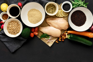 Poster - Healthy food clean eating Сhicken breast vegetables nuts chickpeas quinoa seeds dark stone background copy space top view