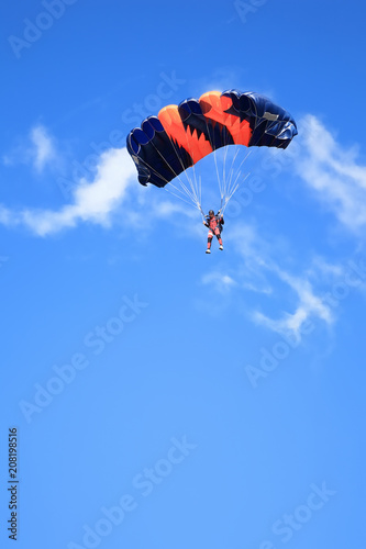 Fotografie, Obraz Paratrooper with open parachute against blue sky