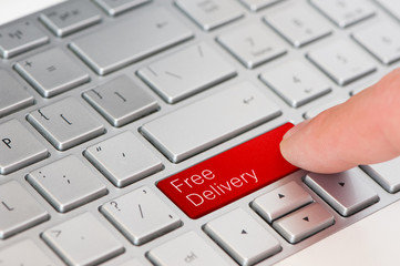 A finger press red free delivery button on laptop keyboard