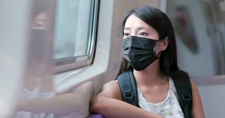 Poster - Woman wearing mask for protection and taking the train in Taipei city metro