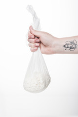 Wall Mural - cropped shot of woman holding cheesecloth sack with cottage cheese isolated on white