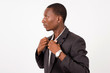 © vystekimages - young businessman standing arranges his shirt glues