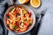 Spicy garlic chilli Shrimps on frying pan with lemon and cilantro