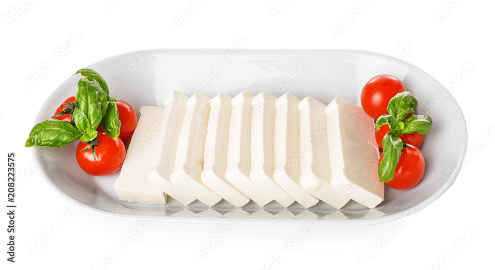 Plate with sliced processed cheese, cherry tomatoes and basil on white background