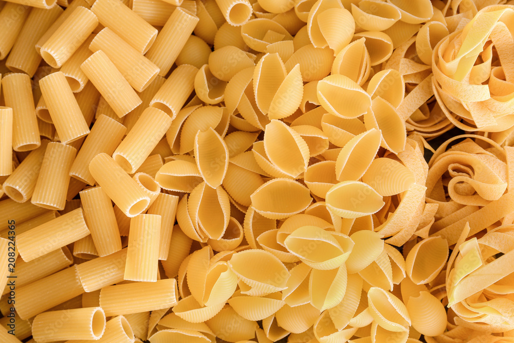 Uncooked pasta as background, closeup