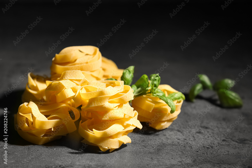 Uncooked fettuccine pasta on table