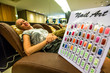 © bennymarty - Close up of nail art handmade, colorful nails. On the blurred background a young smiling  woman while waiting for the manicure in a Thai cosmetic salon.