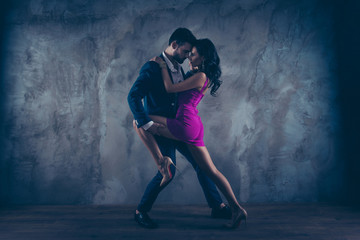 Aufkleber - Full size fullbody portrait of romantic lovely couple, pretty lady in purple tight dress gentlemen in tuxedo, face to face standing close in tango position, isolated on concrete background