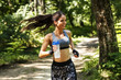 Young woman  jogging outdoor on dirt road at the park .Green environment.