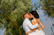 © hreniuca - Beautiful Romantic Wedding Couple Of Newlyweds Hugging In Park On Sunset