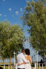 Romanic wedding couple posing in park