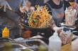 Cooking of street food. Customer service. Soft focus.
