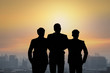 © khwanchai - Silhouette of team businessmen stranding on top of building and looking forward, concept as set goal and teamwork concept