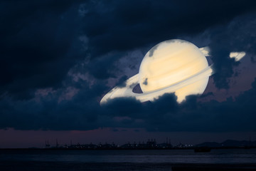 Wall Mural - Saturn back silhouette cloud sunset sky on the sea ,concept Saturn near Earth