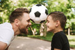 © Drobot Dean - Happy young father have fun with his little son with football