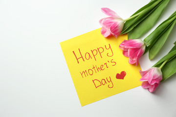  Beautiful tulips and handmade card for Mother's Day on white background