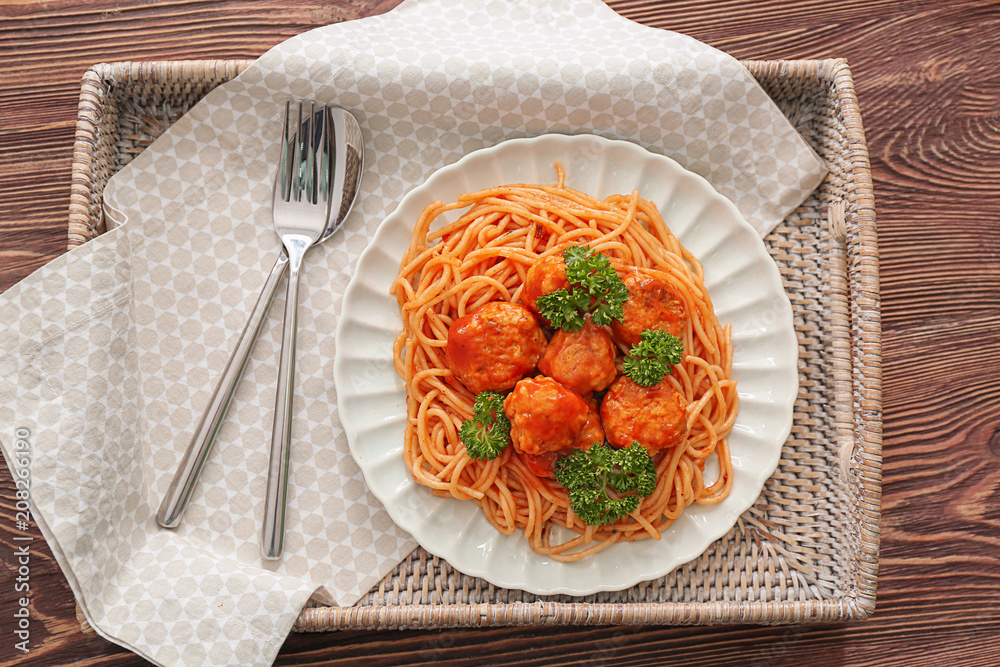 Plate with spaghetti and meatballs on tray. Delicious pasta recipes