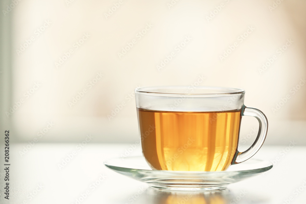 Glass cup of tasty green tea on table