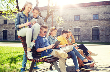 Canvas Print - education, high school and people concept - group of happy teenage students with tablet pc computers at campus yard