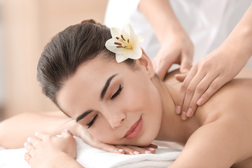 Poster - Young woman enjoying massage in spa salon