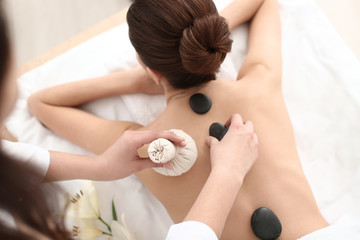 Wall Mural - Young woman enjoying massage in spa salon