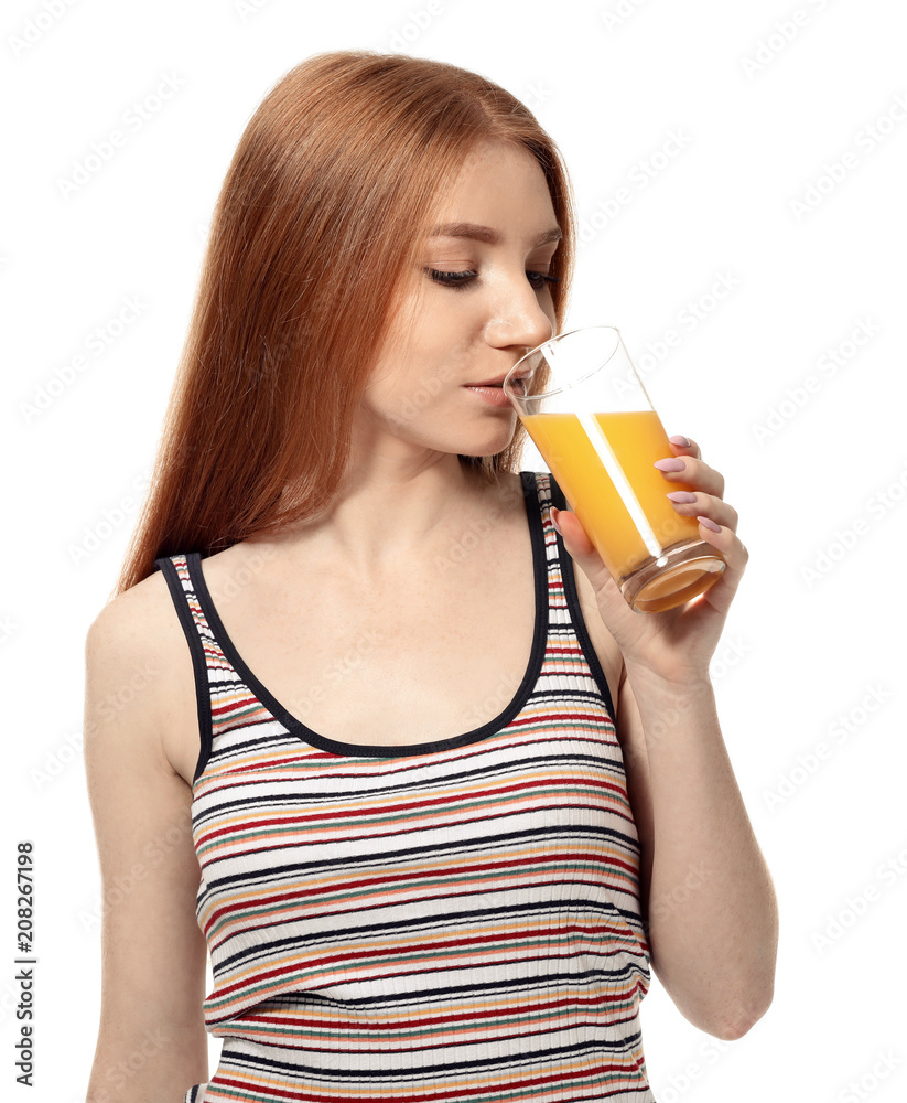 Beautiful young woman drinking citrus juice on white background