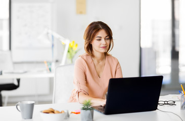 Poster - business, technology and people concept - businesswoman with laptop computer working at office