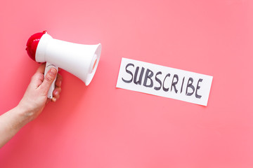 Poster - Subscribe template or mockup. Hand lettering subcribe near megaphone on pink background top view space for text
