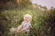 © Lumistudio - adorable caucasian happy smile little girl sitting in a natural clover field playing laughing sumemr holiday natural concept