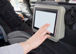 Woman touching blank lcd screen in the travel coach.