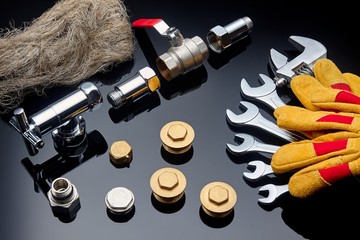 Plumbing accessories on textured dark background.