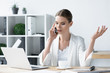 © LIGHTFIELD STUDIOS - confident young businesswoman talking by phone at office