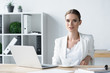 © LIGHTFIELD STUDIOS - successful young businesswoman sitting at workplace in office