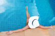 © AnnaMoskvina - Young slim woman in straw hat sitting in swimming pool tropical