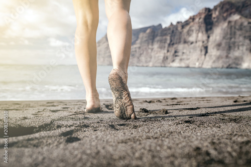 Fotografía Woman barefoot walking on a beach, summer inspiration