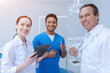 © Viacheslav Yakobchuk - Team work. Positive delighted interns holding its equipment looking straight at camera while being glad to study on dentists