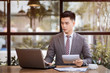 © fatter - Business man working at office with laptop and documents on his desk, consultant lawyer concept