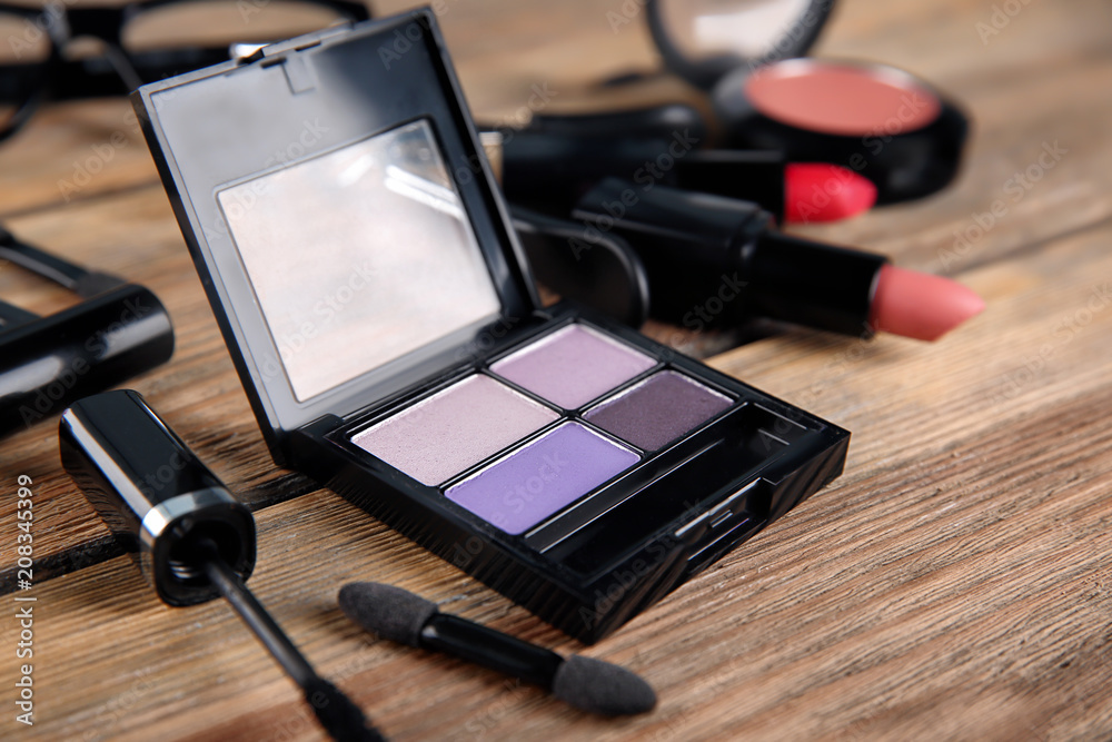 Decorative cosmetics on wooden background