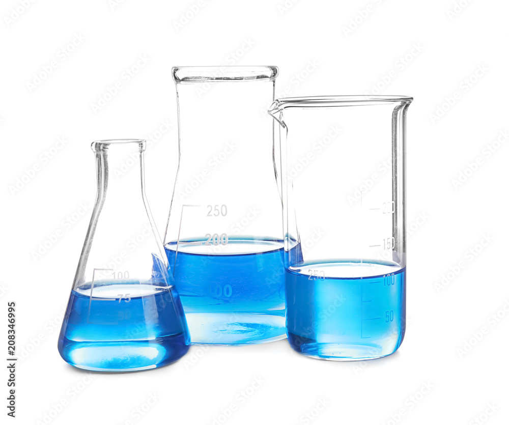Laboratory glassware with blue liquid on white background