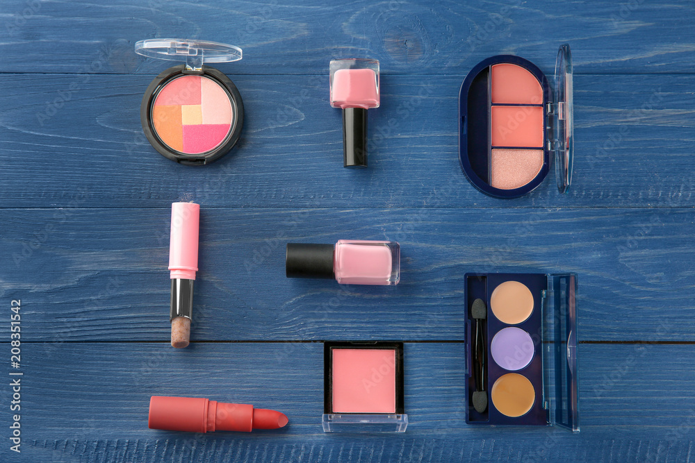 Flat lay composition with professional cosmetics on wooden background