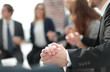 © ASDF - Business group in a circle holding hands indoors