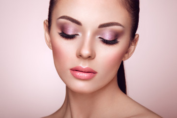 Wall Mural - beautiful young woman with clean fresh skin. perfect makeup. beauty fashion. eyelashes. cosmetic eye
