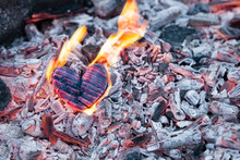 Heart Burns In The Fire. Wooden Heart Was Charred And The Flames On The Coals. The Concept Of Strong Love, Burning Passion, Broken Relationships. Copy Space For Text